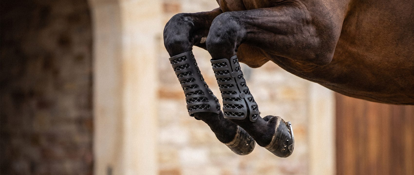 Legs tucked mid-jump, the boots flexing with the horse