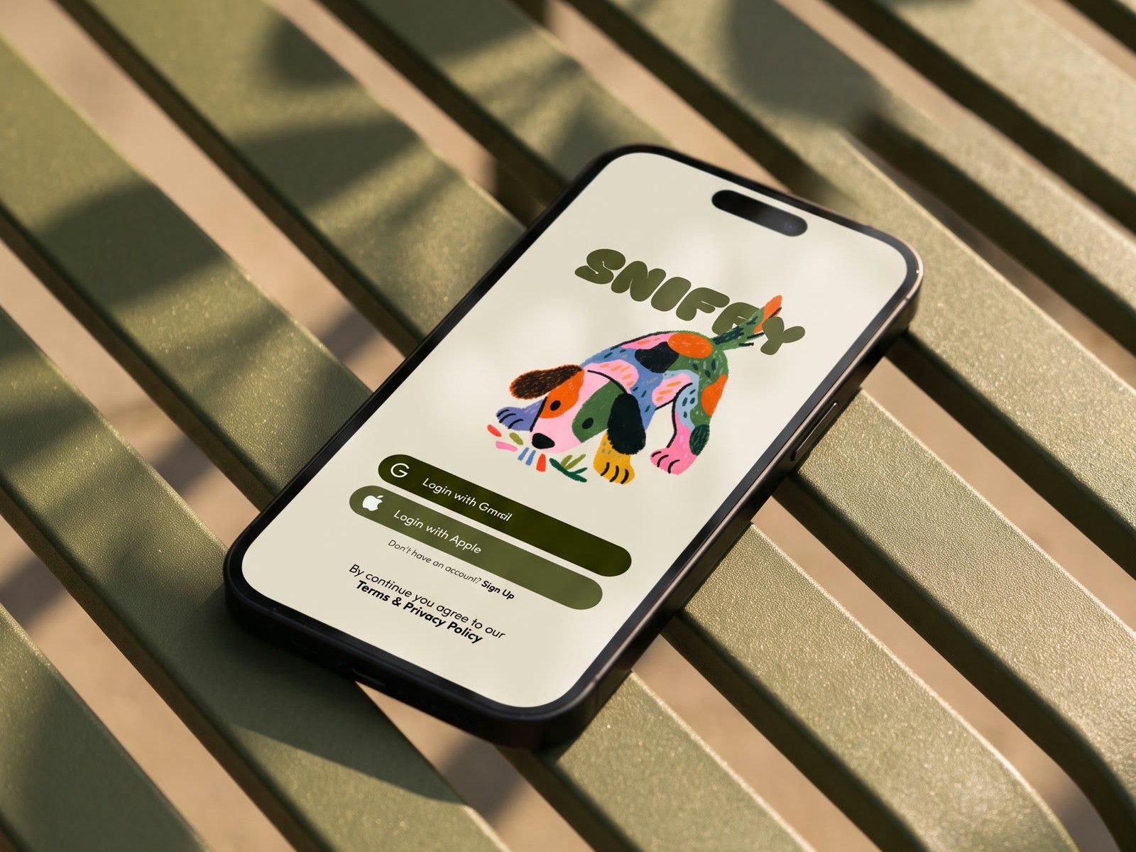 A phone open on the Sniffy sign in screen, lying on a green slatted bench in dappled sun